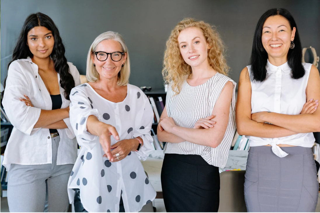Four diverse women standing together confidently