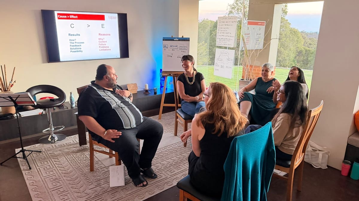 Sheila leading a session with participants seated in the training room