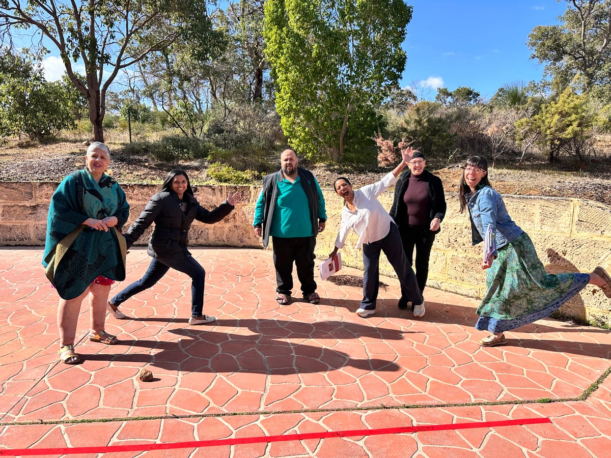 Participants moving and laughing outdoors during a break