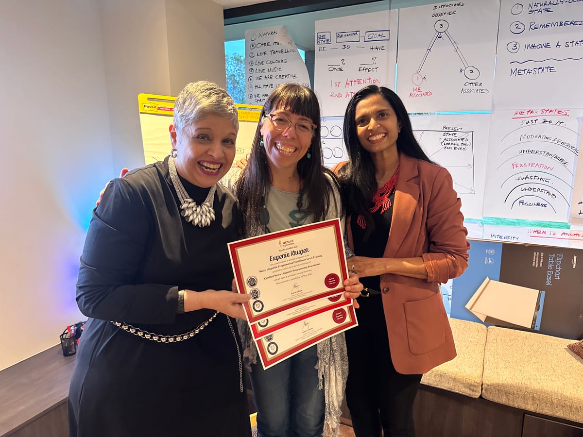 Sheila and Usha presenting a graduate with her certificates