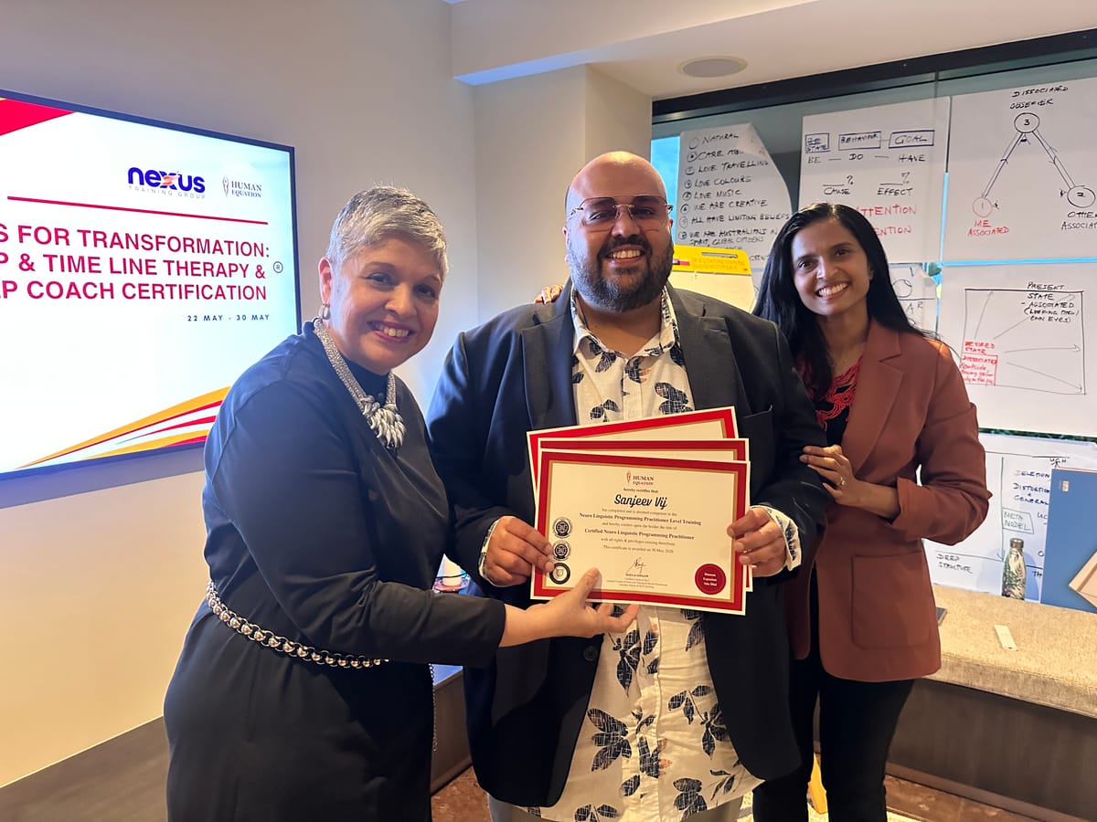 Sheila and Usha presenting a graduate with his certificates