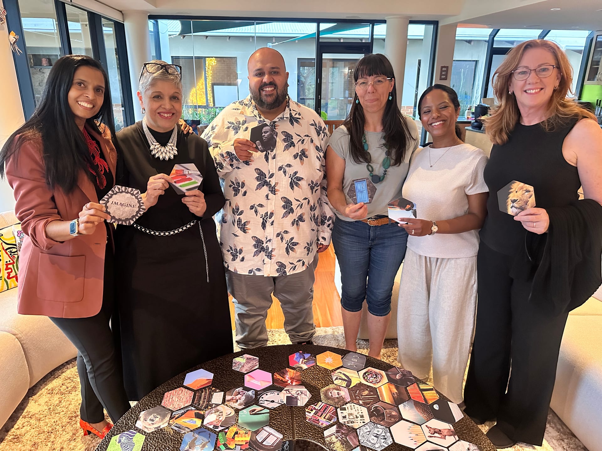 Graduates of the most recent NLP certification course in Perth, smiling and holding their vision cards